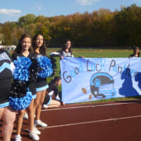 <p>The Rye Neck cheer team waits to welcome the Panthers to their home playoff game.</p>