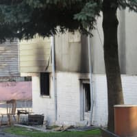 <p>The side of the home, where flames billowed at around 4 a.m.</p>