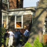 <p>Fire officials investigating the Langdon Avenue fire.</p>