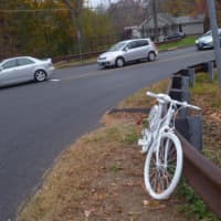 <p>Cars wait at an intersection where Thomas Steinert-Threlkeld  of Weston was killed in a cycling accident on Oct. 20.</p>