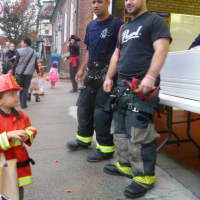 <p>Dobbs Ferry firefighters greet the next generation of firemen at the village&#x27;s Halloween celebration.</p>