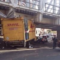 <p>A truck is wedged under the train bridge at Washington Street and South Main Street in South Norwalk on Friday afternoon. </p>