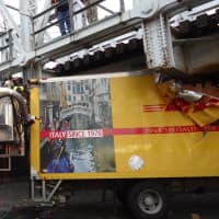 <p>Norwalk firefighters work to cut away the DHL box truck that was stuck under a train bridge at Washington Street on Friday afternoon. </p>