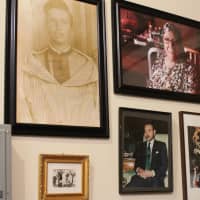 <p>Pictures of Moroccan kings and family members line the walls of the distillery.</p>