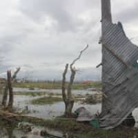 <p>Aid workers from Westport-based Save The Children took photos of the devastation in Tacloban, Philippines, after the storm passed. The building are flattened and more than 3 feet of floodwater is standing in the roads. </p>