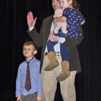 <p>Fairfield RTM representative for District 2 Keith Varian brings his two children up on stage for the swearing in. </p>