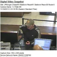 <p>Video images of the armed suspect in the robbery of the Chase Bank at the Somers Commons Shopping Center in Baldwin Place on Tuesday.</p>