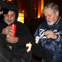 <p>Supporters light each others&#x27; candles.</p>