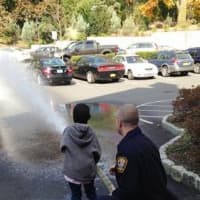 <p>Children from HELP Haven spray the hose during their trip to visit and thank Scarsdale firefighters.
</p>