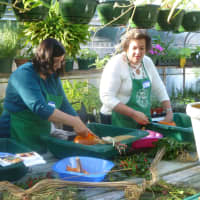 <p>Left to right, Nancy Hodden, Christine Roland and Mary Brunetti make Thanksgiving centerpieces. </p>