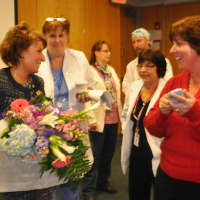<p>Caption: Kathy Webster (center) receives congratulations from the nursing staff. </p>