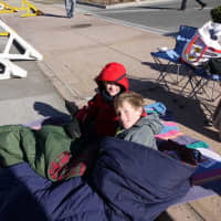 <p>Timmy and William Silkowitz of Stamford brought their sleeping bags to keep warm at the Stamford parade Sunday. </p>