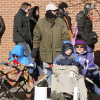 <p>Carl and Lisa Navarro of Danbury brought their sons Ryan and Danny to the parade and were determined to keep warm.</p>