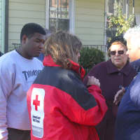 <p>Tamara Garcia-Sanchez, whose home was damaged by the fire, speaks to a Red Cross volunteer. </p>