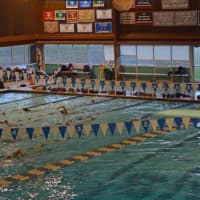 <p>New Canaan diver Kylie Towbin hits the pike position off of the 3-meter board.</p>