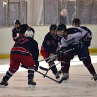 <p>Harvey&#x27;s Corey Eisenband fights for the puck against Stepinac.</p>