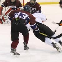 <p>A player on the Harvey School hockey team glides toward the net.</p>