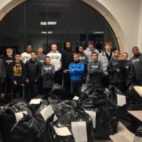 <p>Seventh- and eighth-graders stand with the 35 bags of clothes for the clothing drive. </p>