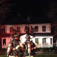 <p>Fairfield firefighters evaluate the situation at the house on Shady Hill Road on Tuesday night. </p>