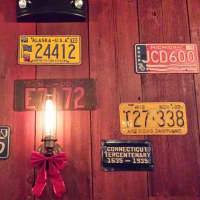 <p>A collection of vintage license plates decorate the walls of the Little Barn in Westport.</p>