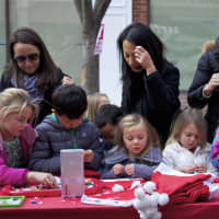 <p>Children make crafts at the Rye Chamber of Commerce Mistletoe Magic festival.</p>