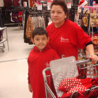<p>Heere Rane and her son volunteer their time to purchase clothes for needy families at the St. Nicholas of Westchester Shopping Day.</p>