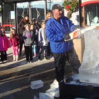 <p>Anthony Tavitian sculpts a penguin from ice at the Holiday Stroll in front of Desires by Mikolay in Chappaqua Saturday.</p>