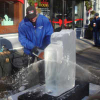 <p>Tavitian makes his first cuts into the 300-pound block of ice to turn it into a penguin.</p>