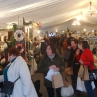 <p>Shoppers peruse the various tables at the Country Living Holiday Bazaar.</p>