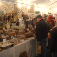 <p>Visitors to the bazaar in Tarrytown shop for jewelry at one of the stands.</p>