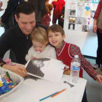 <p>Chris Ryan, Eloise Toothman and Jack Ryan create photo collages at the Katonah Museum of Art&#x27;s Family Portrait Day.</p>