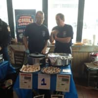 <p>Hastings firefighters Brian Schnibbe and Don Wemer at the Chili Cookoff on December 8.</p>