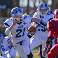 <p>Darien&#x27;s John Reed runs behind Nick Lombardo during the Thanksgiving game against New Canaan.</p>