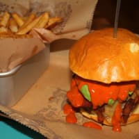 <p>The &quot;Roadhouse&quot; comes with pepperjack cheese, country bacon, hass avocado, fire roasted red peppers,
sweet apple grilled onions and smoked paprika mayo ($12.15, recommended with bison). </p>