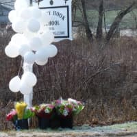 <p>Balloons and flowers honor the fallen students and educators at the sign for Sandy Hook School in Newtown, Conn.</p>