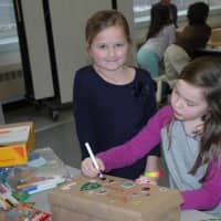 <p>Students work on boxes that will be distributed to children in need in Bridgeport.</p>