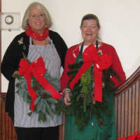 <p>Pound Ridge Garden Club president Annie Thom, left, and Amanda Sutton, chair of the holiday decorating effort, display swags. </p>