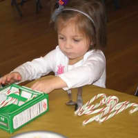 <p>A child attends the annual Christmas dinner put on by the Congregation Sons of Israel at the Ossining Presbyterian Church.</p>