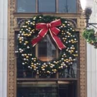 <p>A giant Christmas wreath hangs over the door at the Bank of America in downtown Stamford. </p>
