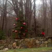 <p>A Redding home&#x27;s stone wall is decorated for the holidays with reindeer, wreaths, bows and a fully decked Christmas tree. </p>