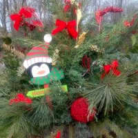 <p>A planter filled with a penguin, boughs and bows brightens the area near the post office. </p>