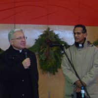 <p>Father Paul Waddell leads 300 people in singing &quot;Silent Night&quot; at the 20th annual Westchester Community Christmas Day Dinner</p>