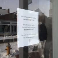 <p>The snow is reflected in the window at Intermix in downtown Westport, which is closed until Saturday due to the snow. </p>