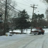 <p>A snow plow gets to work on Long Lots Road in Westport. </p>