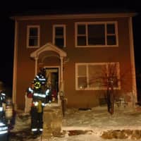 <p>Norwalk firefighters approach the home on South Main Street, where a late-night blaze injured two residents. </p>