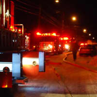 <p>Firefighters put out the hose to fight the late night blaze in the icy cold. </p>