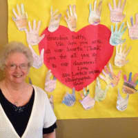 <p>&quot;Grandma Betty&quot; standing with a project made for her by students.</p>
