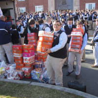 <p>Students bringing food to canned drive. </p>