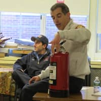 <p>Eastchester Fire Capt. Thomas Pintaville demonstrating the proper utilization of a fire extinguisher.</p>