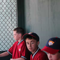 <p>The New Rochelle Braves in their dugout at the Cooperstown Hall of Fame tournament last summer.</p>
